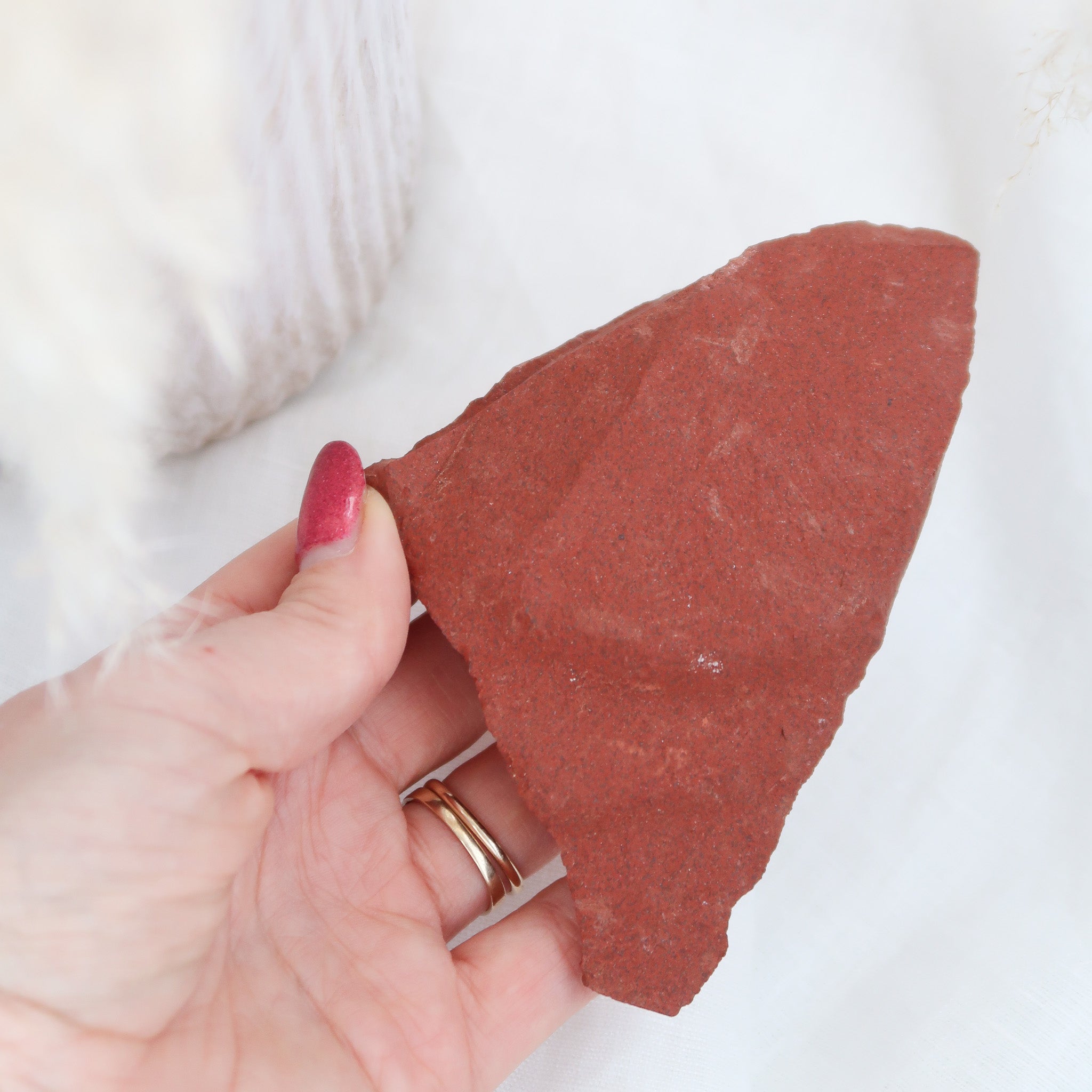 Raw Red Jasper being held