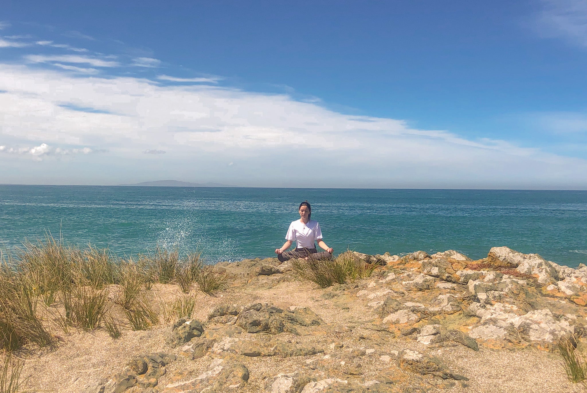 Woman Meditating on the beach